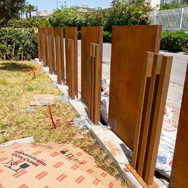 Installation de panneaux et de montants en acier Corten pour une clôture extérieure au Maroc